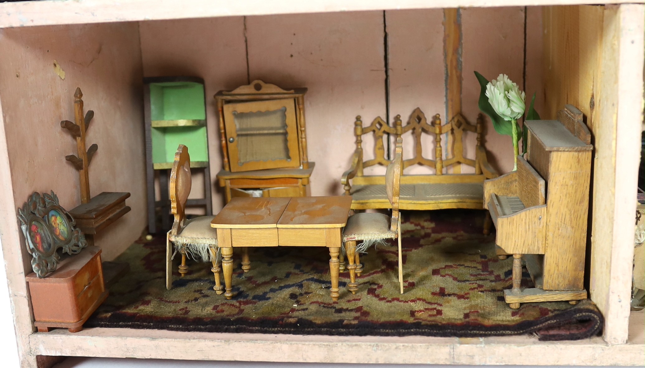 A Victorian furnished dolls’ house, circa 1890, 77cm high.
